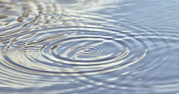 Closeup of concentric water ripple circles in fresh water