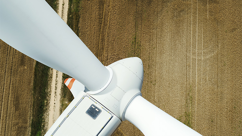 Wind turbine photo from above looking over a field.